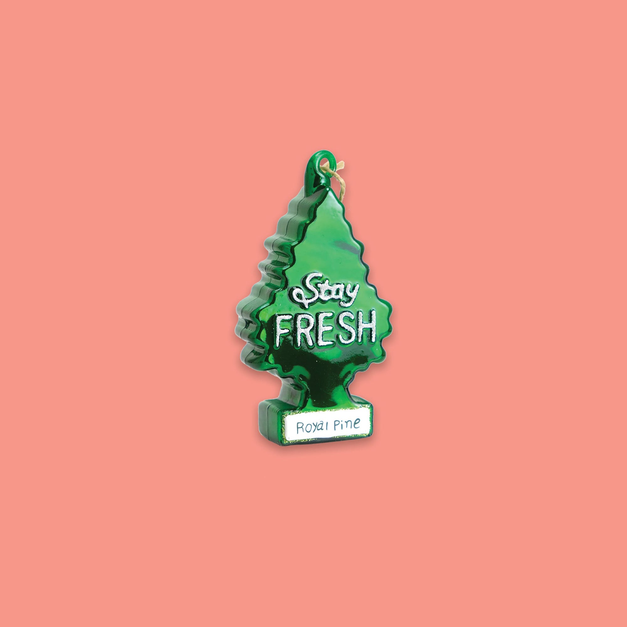 On a coral pink background sits an ornament. This glass ornament is of a green christmas tree and in white glitter it says "Stay FRESH" in hand lettering. On the bottom it says "Royal Pine" in green on a white background.
