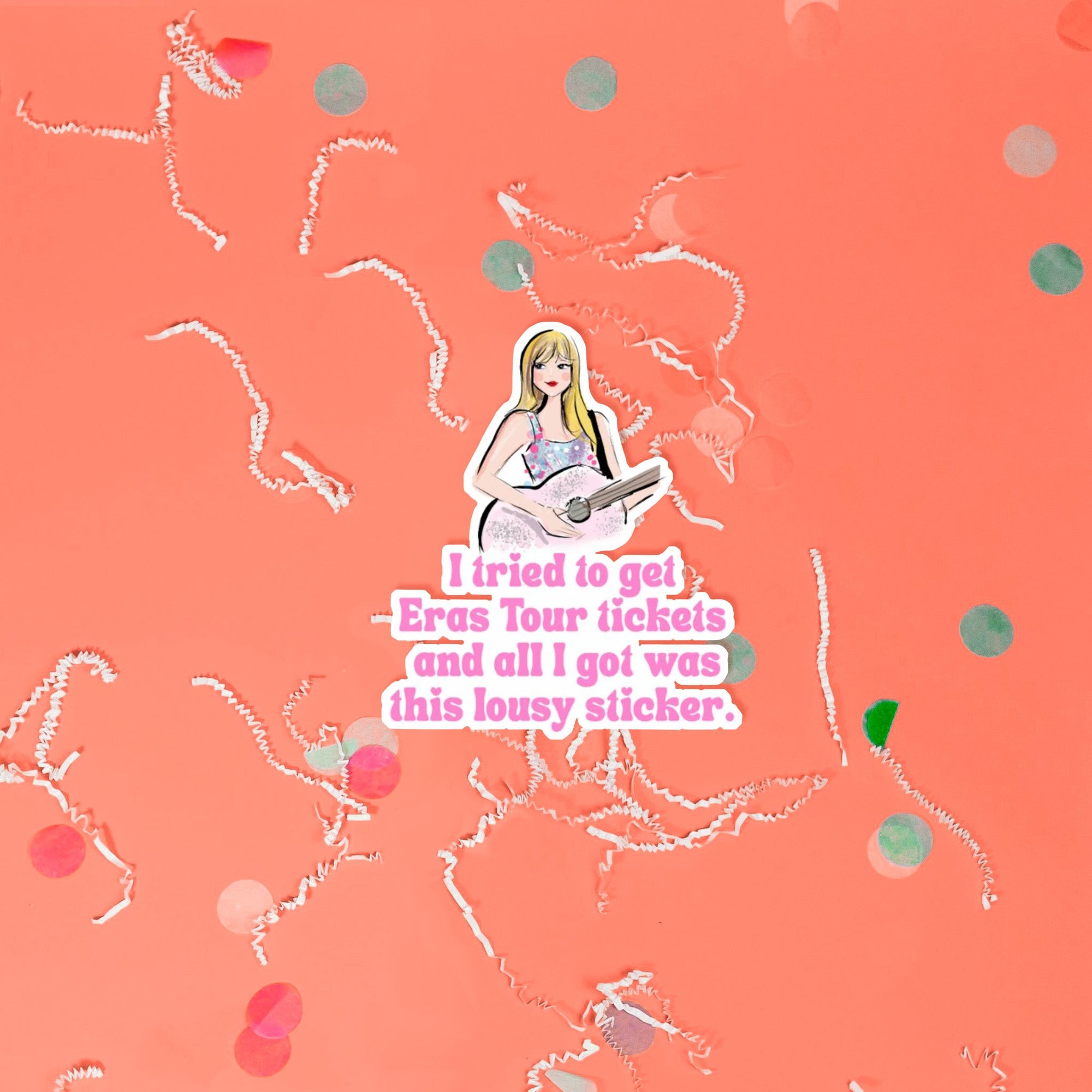 On a coral pink background sits a sticker with white crinkle and big, colorful confetti scattered around. This Taylor Swift inspired sticker is an illustration of Taylor Swift holding a pink glitter guitar and it says "I tried to get Eras Tour tickets and all I got was this lousy sticker" in bubblegum pink lettering.