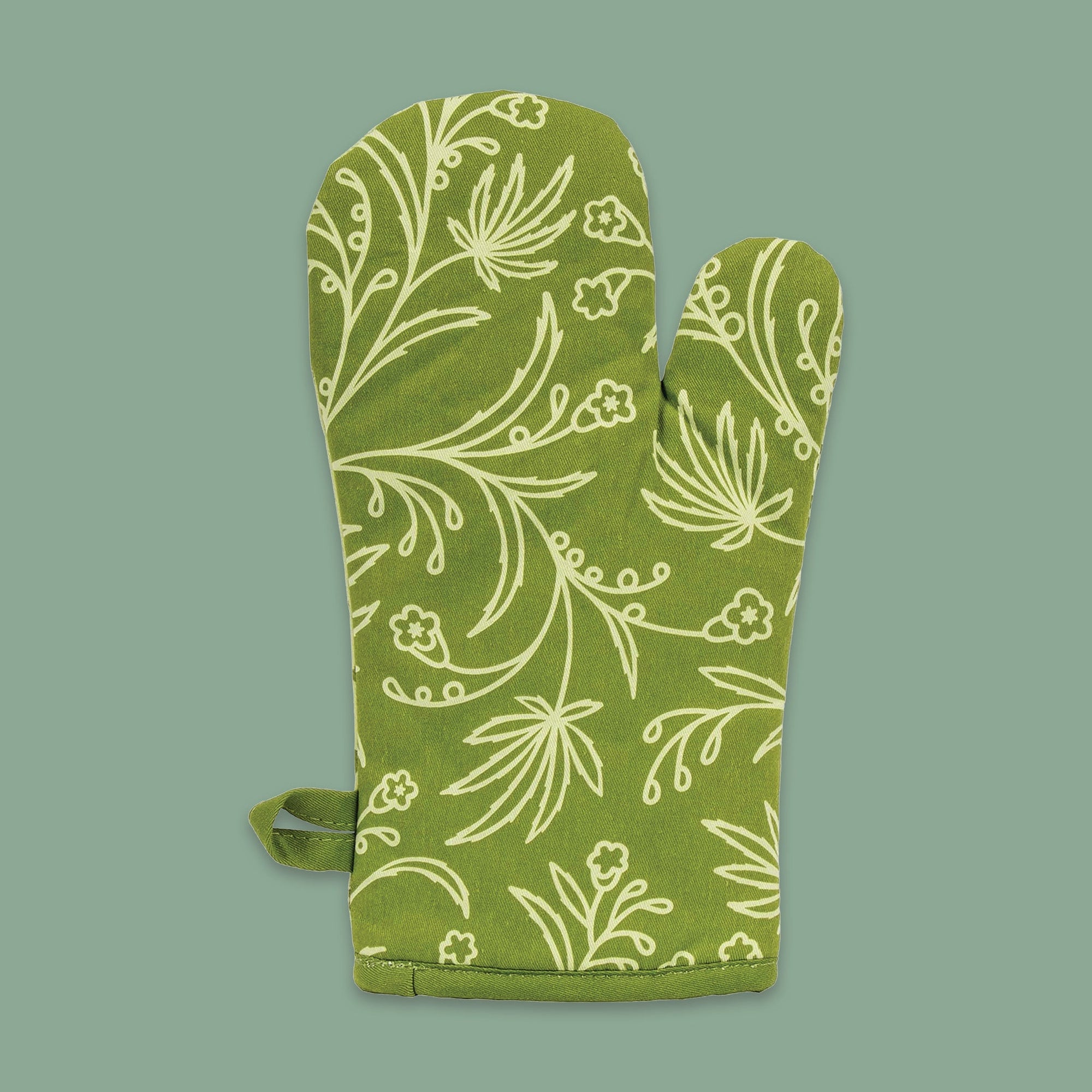 On a moss green background sits an oven mitt. The back of this green oven mitt has illustrations of celery green marijuana leaves and flowers on it.