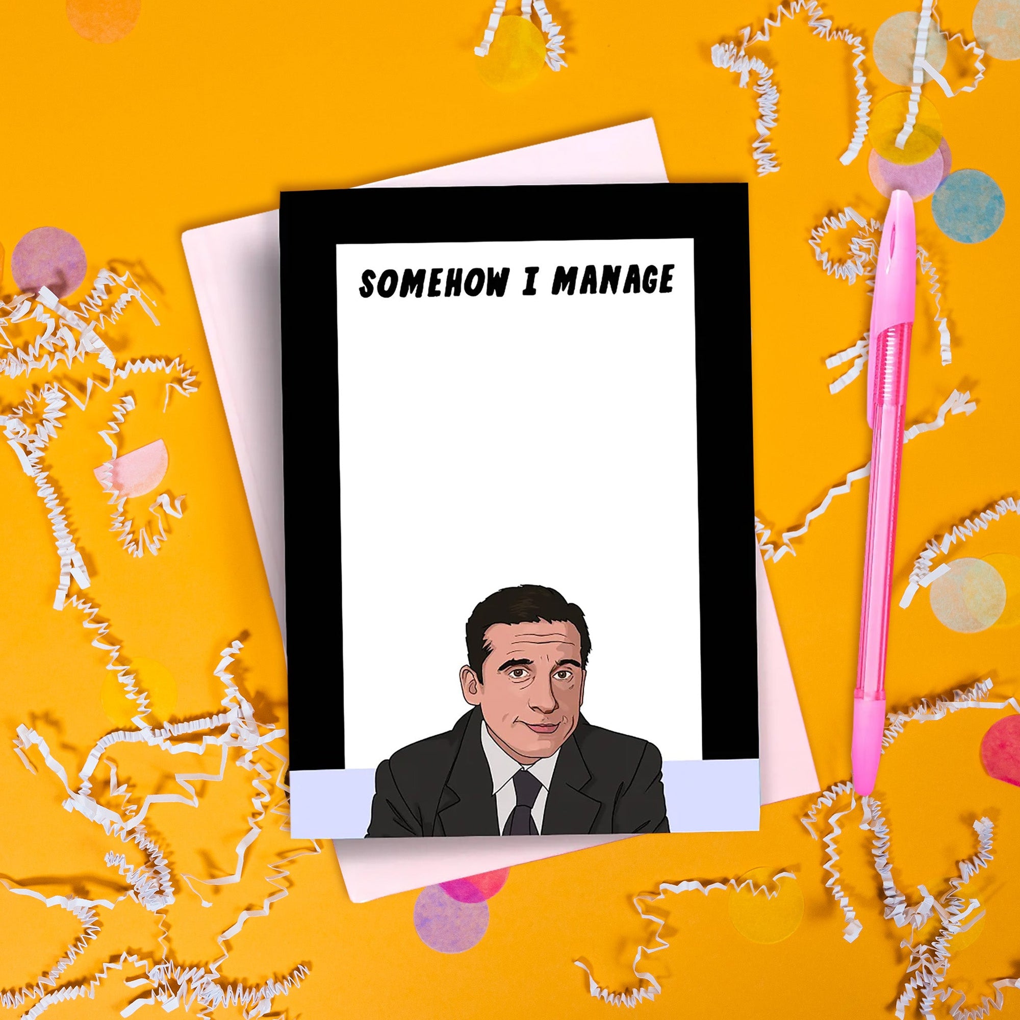 On a sunny mustard background sits a notepad with a pen. There is white crinkle and big, colorful confetti scattered around. The Office inspired notepad has a black and lavender border with a white recangle on top. It says at the top "SOMEHOW I MANAGE" in black, all caps handwritten lettering. On the bottom is an illustration of Michael Scott wearing a black suit and black tie with white shirt.