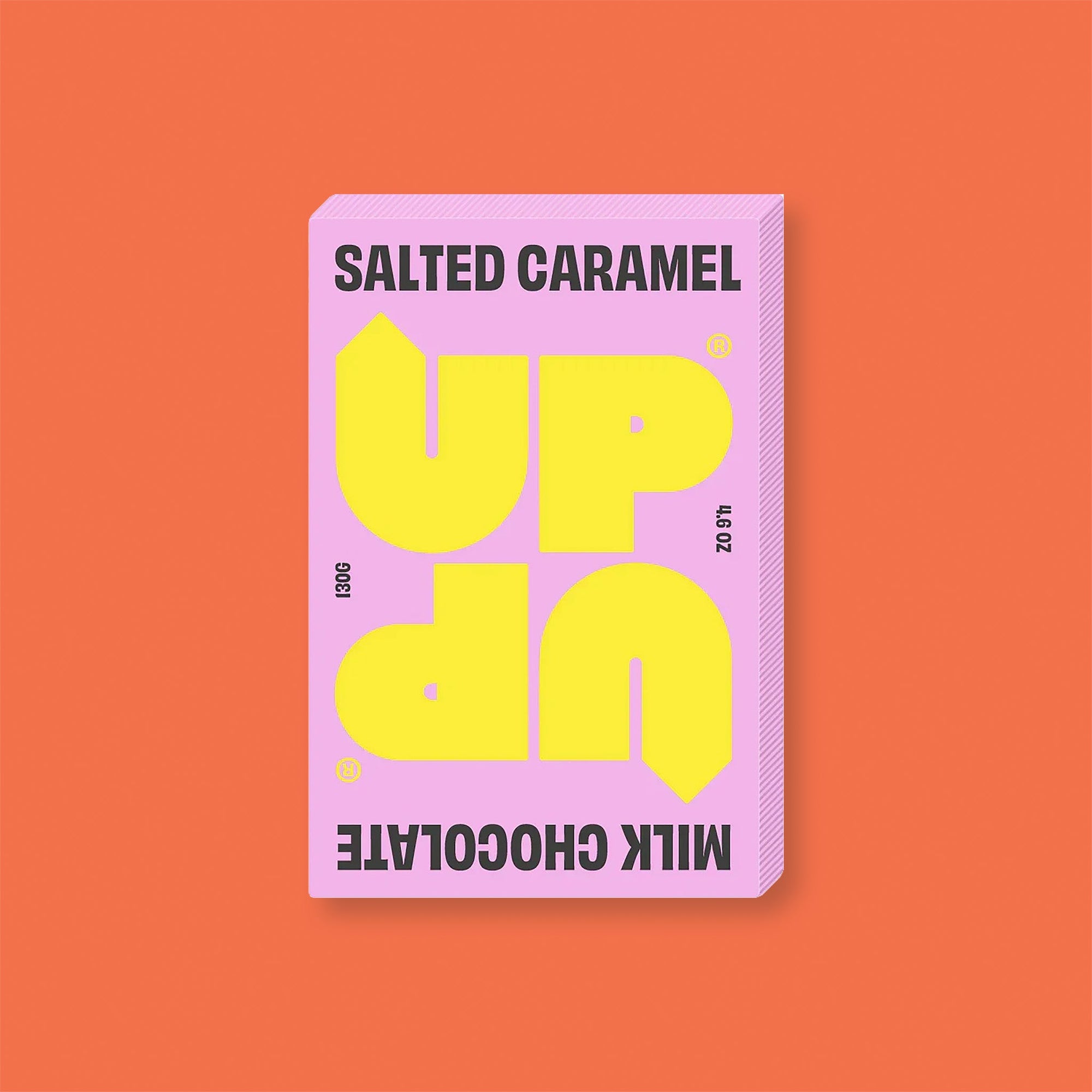 On an orangey-red background sits a box of UP UP Milk Chocolate. The packaging is in mint green and orangey-red.