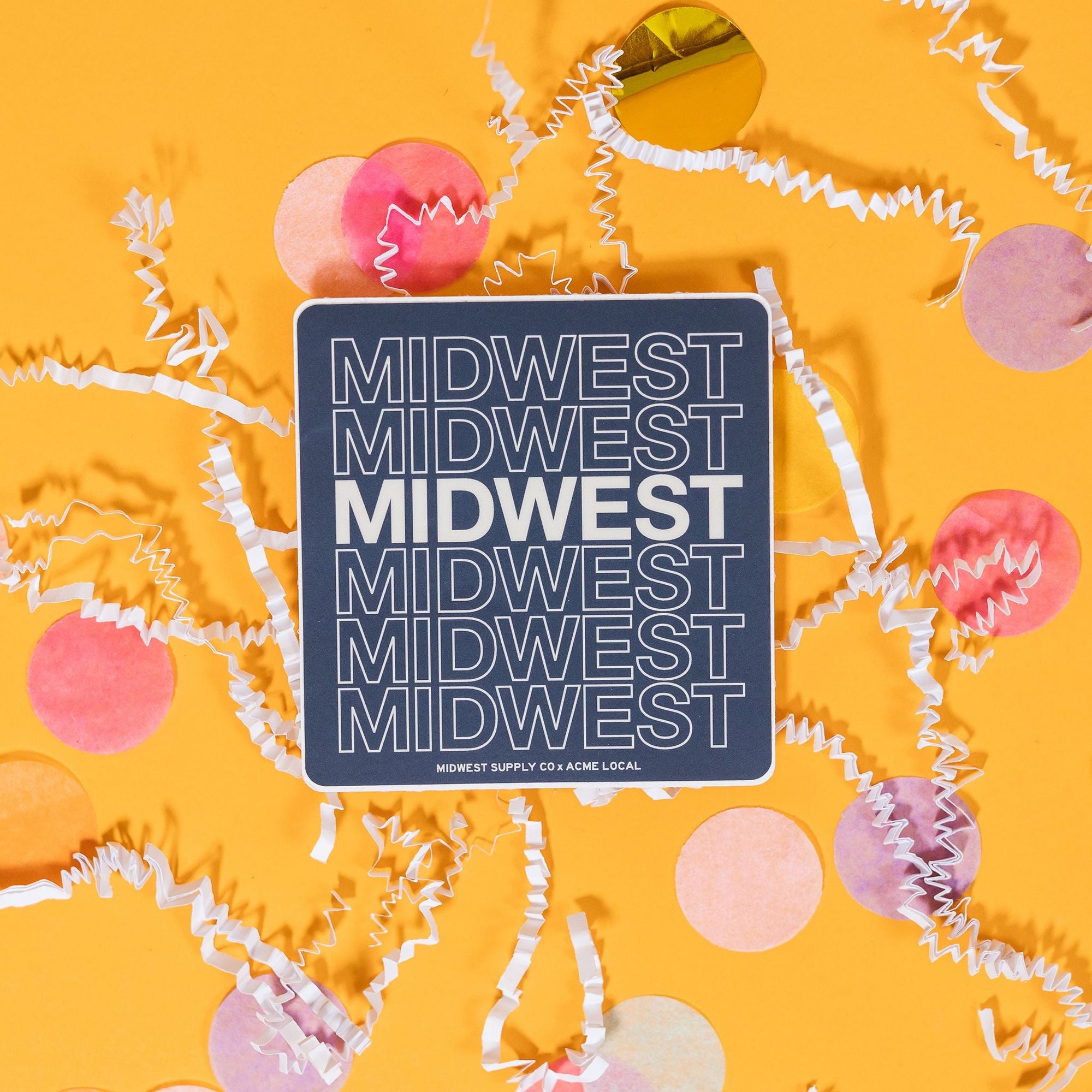 On a sunny mustard backgroudn sits a sticker with white crinkle and big, colorful confetti scattered around. This navy sticker says "MIDWEST MIDWEST MIDWEST MIDWEST MIDWEST MIDWEST" stacked in white block font. Five of the words are in white outline and one is in solid white. 2"-3"